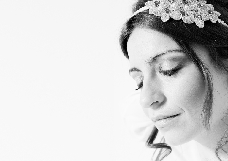 retrato en blanco y negro de primer plano, la modelo Sharai situada un poco de perfil en el lado derecho de la fotografía y el resto en blanco, aparece con los ojos cerrados y pensativa realizada por Alberto Cossío Fotografía de moda